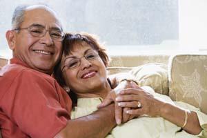 Older couple hugging on couch