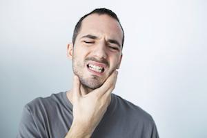 man holding jaw from pain | emergency dentistry mount waverley vic