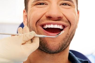 Happy man getting dental exam in mount waverley