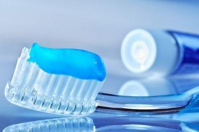 close up of tooth brush with blue toothpaste on it