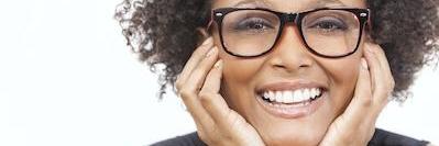 woman with glasses smiling