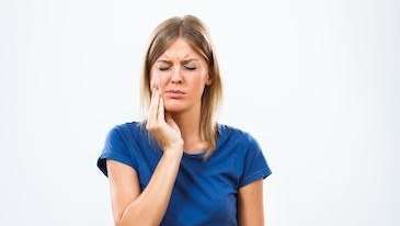 mount waverley woman holding jaw from tooth pain