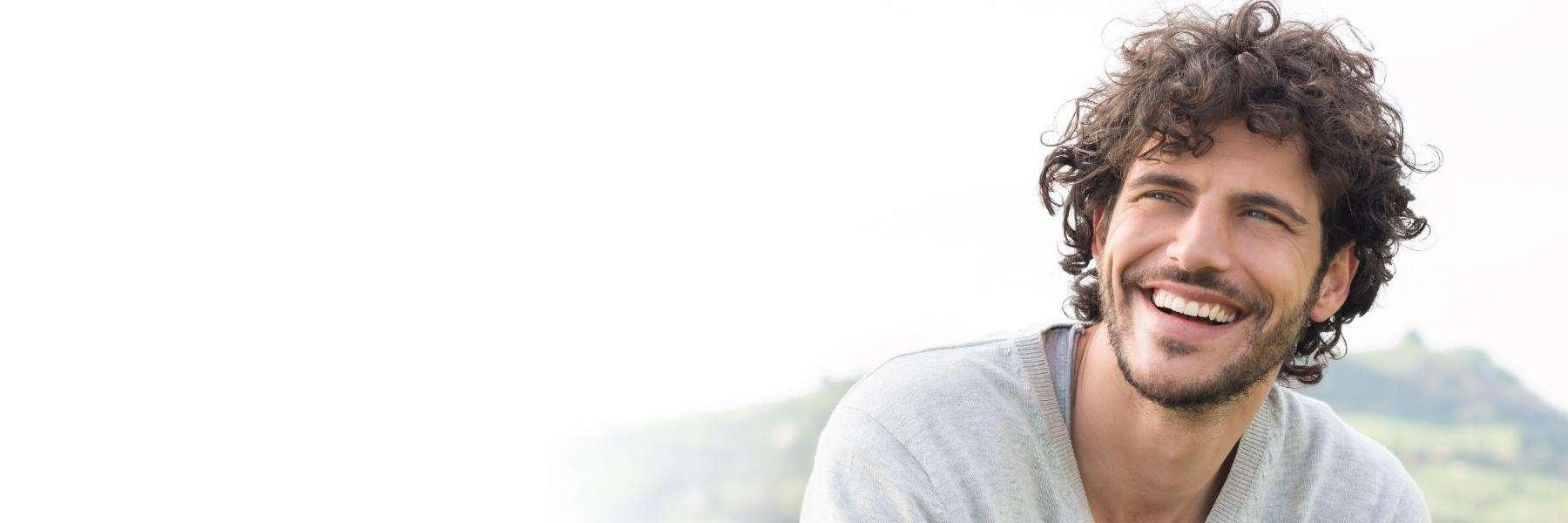 young man with dental implants in mount waverly