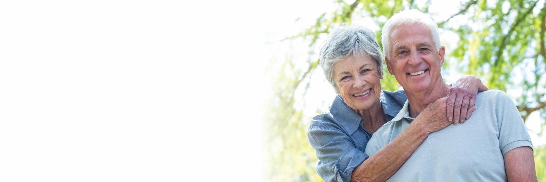 Older man and woman smiling outside